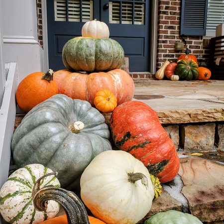 A Marietta porch decorated with stacked pumpkins